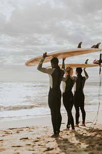 Happy friends surfing at the beach
