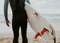 Man at the beach with his surfboard