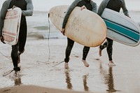 Happy friends surfing at the beach