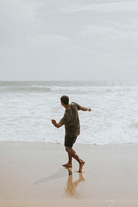 Man throwing a stone into the sea