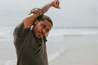 Black man stretching on the beach