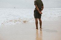 Black man standing by the seaside