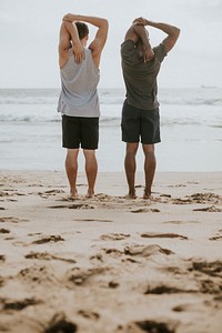 Men stretching on the beach