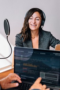 Female broadcaster interviewing her guest in a studio