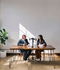 Female broadcaster interviewing her guest in a studio