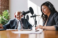 Female broadcaster interviewing her guest in a studio