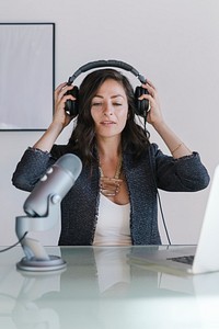 Female radio host broadcasting live in a studio