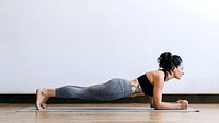 Sporty woman doing yoga in the room