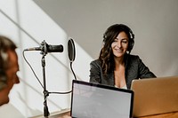 Female broadcaster interviewing her guest in a studio