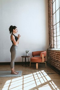 Sporty woman in Anjali Mudra pose