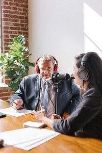 Female broadcaster interviewing her guest in a studio