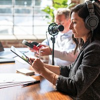 Female broadcaster interviewing her guest in a studio