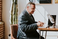 Radio host writing on a notebook