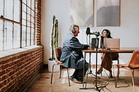 Female broadcaster interviewing her guest in a studio