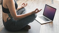 Active woman learning yoga online via a laptop