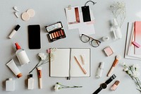 Beauty products on a table with a notebook