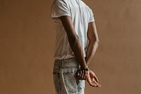 Black man standing by a beige background