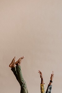 Black man with his feet and hands in the air