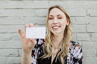 Cheerful white woman showing her business card