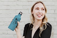 Happy woman carrying a thermal bottle mockup