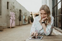 Happy woman using a digital tablet outdoors