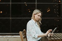 Happy woman using a digital tablet outdoors