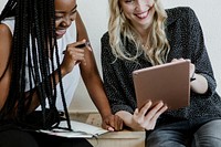 Diverse friends enjoying using the digital tablet