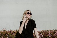 Happy woman talking on the phone in the garden