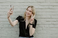 Cheerful blond woman taking a selfie