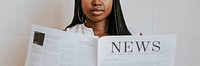 Black woman reading a newspaper