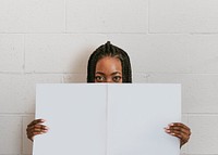 Black woman holding a blank newspaper mockup