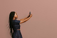 Black woman taking a selfie with her smartphone