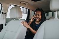 Happy woman on the phone in a car