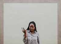 Serious black woman with her phone in a hand
