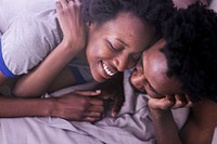 Cute happy black couple playing in bed