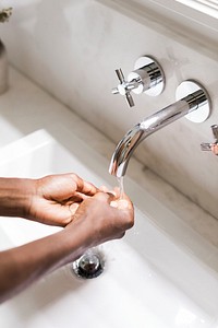 Black woman washing her hands