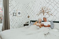 Couple using a phone on the bed