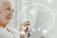 Elderly woman using a tablet on a couch