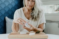 Senior woman rolling a joint