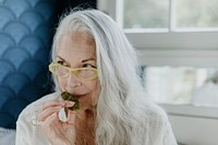 Senior woman smelling a weed