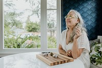 Senior woman holding a joint in her hand