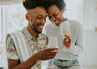 Happy couple enjoying a glass of wine in the kitchen