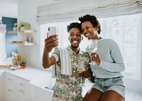 Happy couple taking a selfie in the kitchen