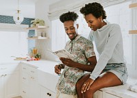 Cute black couple taking notes in the kitchen