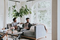 African couple chilling in a living room at home