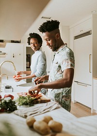 Happy black couple cooking in the kitchen
