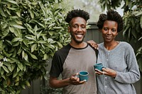 African American couple with coffee in the garden