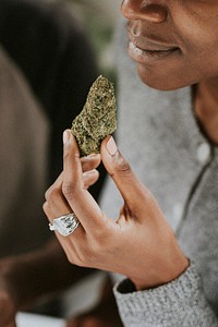 Woman holding weed in hand