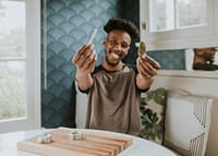 A man holding a joint and weed in hand