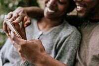 Happy black couple using a smartphone